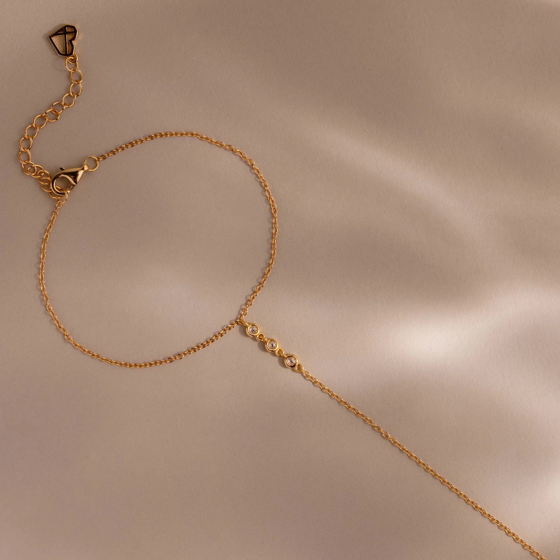 Close-up of Ava Drop Chain Bracelet showing delicate CZ diamond drop charm and fine linked chain.